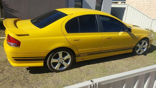 A yellow Falcon XR sedan