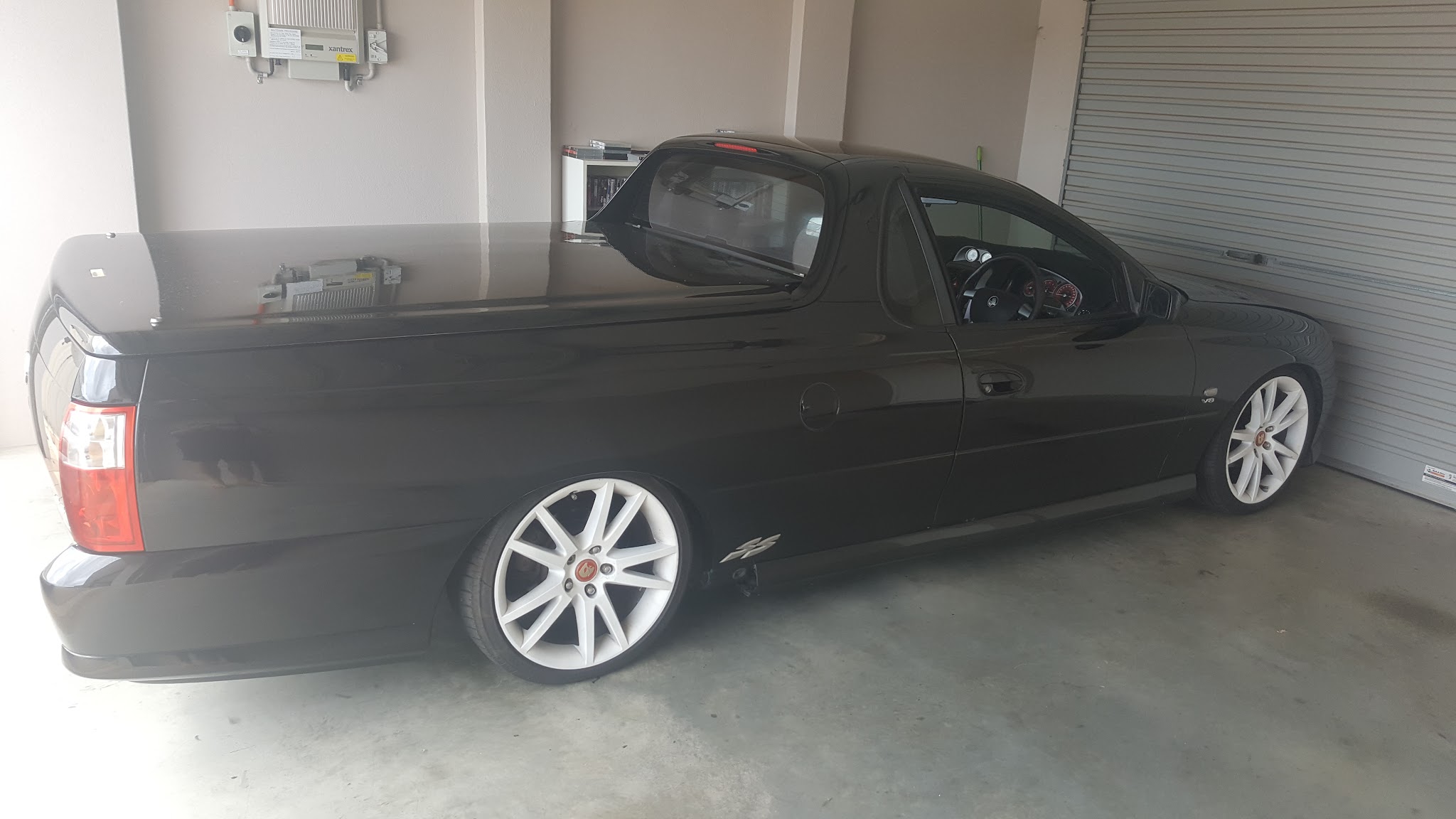 A black V8 Commodore ute in the workshop