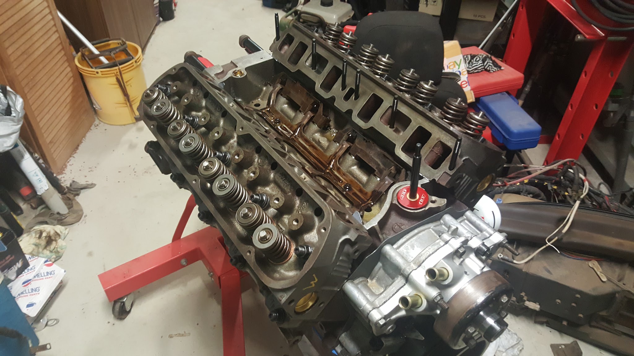 A V8 engine stripped down on an engine stand in the workshop