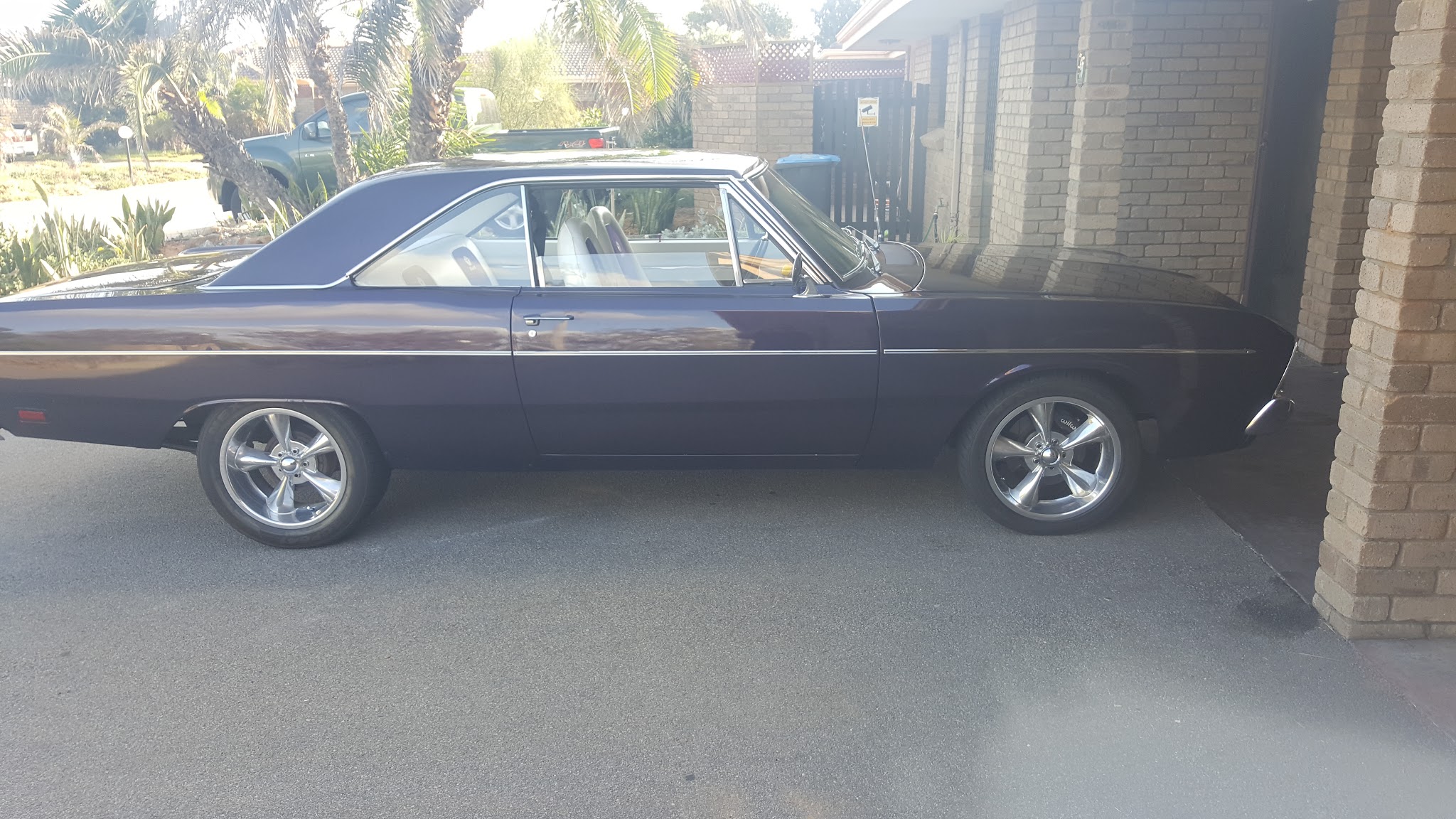 A restored purple Chrysler coupe on polished alloys